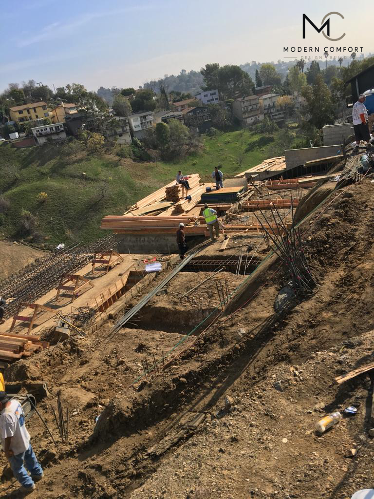 Hillside excavation and retaining wall construction on a steep slope