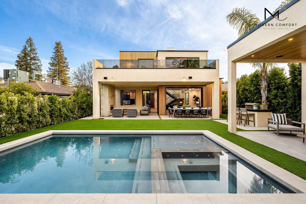 Custom home backyard with swimming pool, spa, and covered outdoor living area