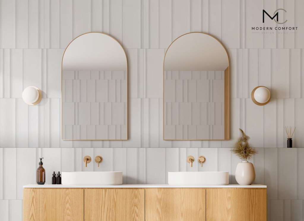 Spa-style bathroom with double vessel sinks, arched mirrors, and oak vanity